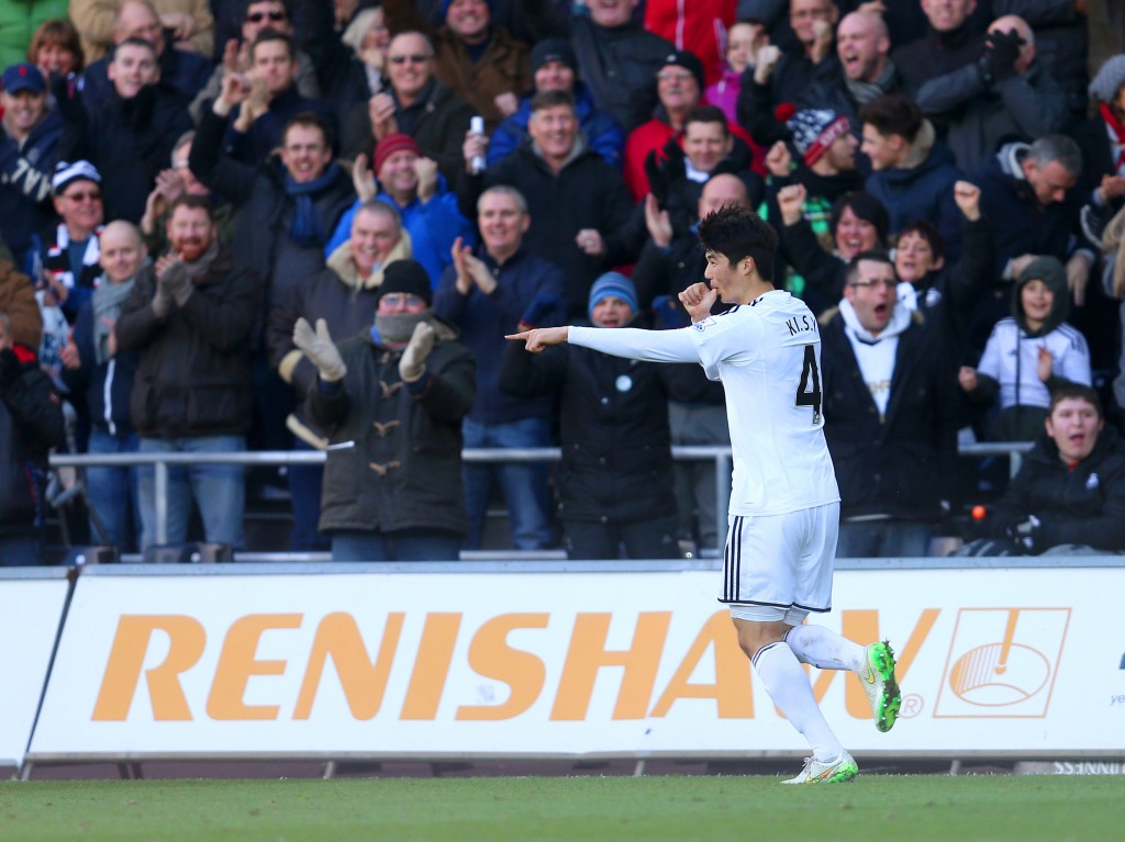 Swansea City's Sung-Yeung Ki celebrates scoring his side's first goal of the match during their English Premier League soccer match against Manchester United at the Liberty Stadium, Swansea, Wales, Saturday, Feb. 21, 2015. (AP Photo/David Davies, PA Wire)  