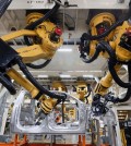 Robots install rivets on a 2015 Ford F-150 truck at the Dearborn Truck Plant in Dearborn, Mich. Cheaper, better robots will replace human workers in the world's factories at a faster pace over the next decade, pushing manufacturing labor costs down 16 percent, a report from the Boston Consulting Group said Tuesday, Feb. 10, 2015. (AP Photo/Paul Sancya)