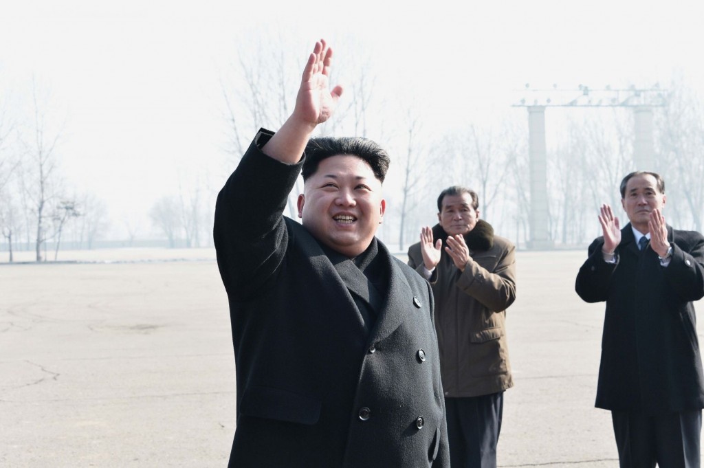 North Korean leader Kim Jong-un waves to construction workers at an event in Pyongyang in this photo released by KCNA on Feb. 12, 2015. (No sale outside of South Korea) (KCNA-Yonhap)