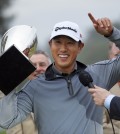 James Hahn holds the winner's trophy after his one-stroke victory on the third playoff hole against two other players in the final round of the Northern Trust Open golf tournament at Riviera Country Club in the Pacific Palisades area of Los Angeles Sunday, Feb. 22, 2015.(AP Photo/Mark J. Terrill)