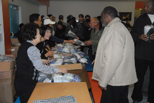 JABI Charity Association volunteers hand out underwear sets to the homeless at Cityteam.