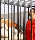 This still image made from video released by Islamic State group militants and posted on the website of the SITE Intelligence Group on Tuesday, Feb. 3, 2015, purportedly shows Jordanian pilot Lt. Muath al-Kaseasbeh standing in a cage just before being burned to death by his captors. The death of the 26-year-old pilot, who fell into the hands of the militants in December when his Jordanian F-16 crashed near Raqqa, Syria, followed a weeklong drama over a possible prisoner exchange. (AP Photo/SITE Intelligence Group)