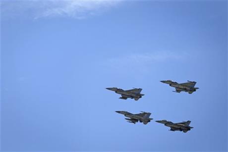 Jordanian Air Force fighter jets fly during the funeral of slain Jordanian pilot, Lt. Muath al-Kaseasbeh, at his home village of Ai, near Karak, Jordan, Wednesday, Feb. 4, 2015. Outrage and condemnation poured across the Middle East on Wednesday as horrified people learned of the video purportedly showing the Islamic State group burn a Jordanian pilot to death. (AP Photo/Nasser Nasser)
