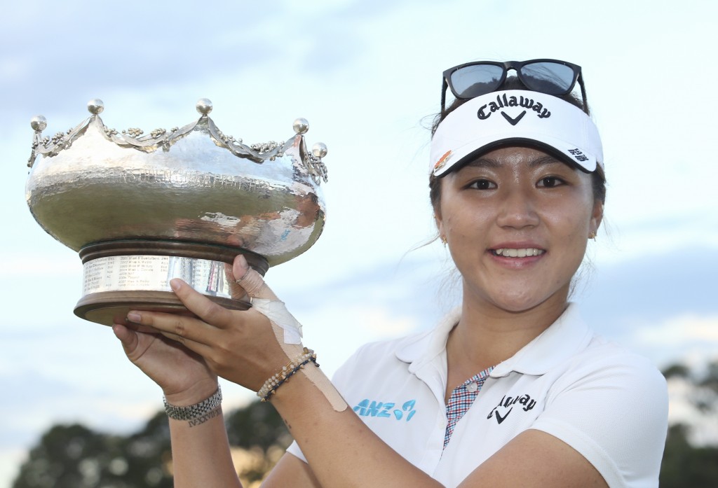 Lydia Ko of New Zealand poses with her winners trophy after she won the Women's Australian Open Golf tournament at the Royal Melbourne Golf Club in Melbourne, Australia Sunday, Feb. 22, 2015. (AP Photo/AAP, David Crosling)