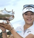 Lydia Ko of New Zealand poses with her winners trophy after she won the Women's Australian Open Golf tournament at the Royal Melbourne Golf Club in Melbourne, Australia Sunday, Feb. 22, 2015. (AP Photo/AAP, David Crosling)