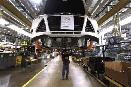 FILE - In this Dec. 14, 2011, a line worker assembles a 2012 Ford Focus at the Ford Michigan Assembly plant in Wayne, Mich. The jobs report on Friday, Feb. 6, 2015, signaled that raises have finally begun to flow through an economy in which, once you factor in inflation, most people earn less than when the Great Recession struck in 2007. Ford has announced that up to 500 of its lowest-paid factory workers will receive a 48 percent pay raise to $28.50 an hour. Other major companies, including Aetna and the Gap, have also announced pay increases. (AP Photo/Paul Sancya)