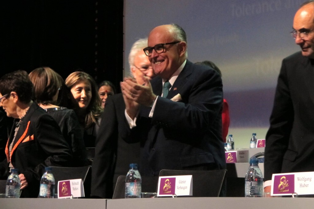 Former New York City Mayor Rudy Giuliani claps at the start of a day-long conference on human rights organized by the Iranian exile opposition group National Council of Resistance of Iran on Saturday, March 7, 2015. Giuliani was one of the main speakers. (AP Photo/Frank Jordans)