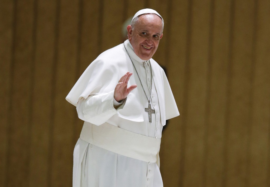 Pope Francis waves to faithful as he arrives on the occasion of an audience with participants to the course promoted by the Penitentiary Apostolic Tribunal, in the Paul VI hall at the Vatican,  Thursday, March 12, 2015. (AP Photo/Andrew Medichini)