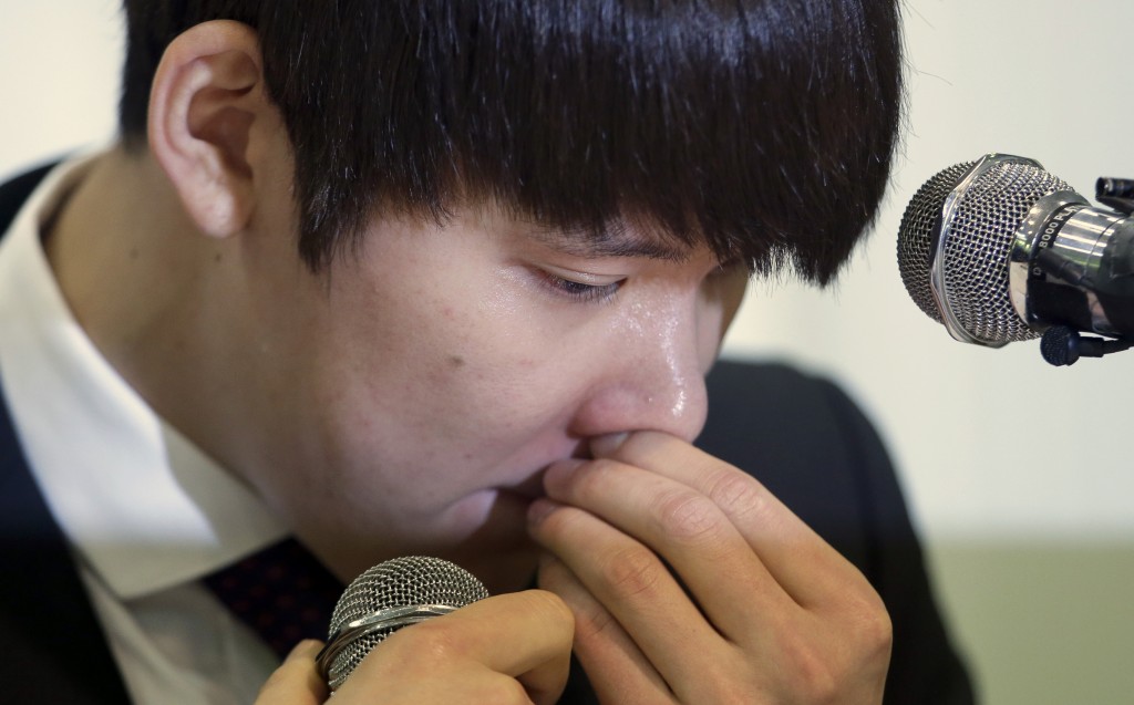 Former Olympic swimming champion Park Tae-hwan of South Korea holds back his tears during a news conference in Seoul, South Korea, Friday, March 27, 2015. Former Olympic swimming champion Park Tae-hwan of South Korea offered a public apology Friday, four days after receiving an 18-month ban for failing a doping test. (AP Photo/Lee Jin-man)