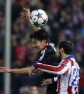 Leverkusen's Son Heung-min, left and Atletico's Juanfran hump for a high ball during the Champions League round of sixteen second leg soccer match between Atletico de Madrid and Bayer 04 Leverkusen at the Vicente Calderon stadium in Madrid, Spain, Tuesday, March 17, 2015. (AP Photo/Andres Kudacki)