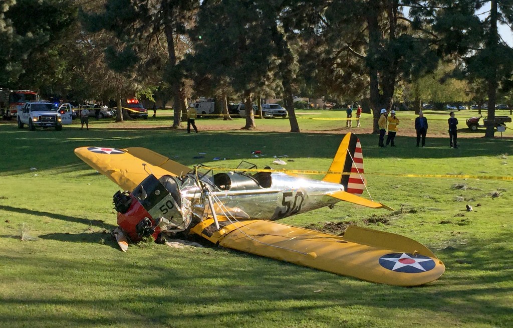 A small plane lies where it crash-landed on Penmar Golf Course in the Venice area of Los Angeles on Thursday, March 5, 2015. The course is near the Santa Monica, Calif. Municipal Airport, just west of a runway, but there was no immediate confirmation on whether the plane had taken off or was trying to land. (AP Photo/Damian Dovarganes)
