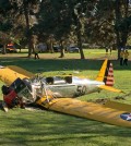 A small plane lies where it crash-landed on Penmar Golf Course in the Venice area of Los Angeles on Thursday, March 5, 2015. The course is near the Santa Monica, Calif. Municipal Airport, just west of a runway, but there was no immediate confirmation on whether the plane had taken off or was trying to land. (AP Photo/Damian Dovarganes)