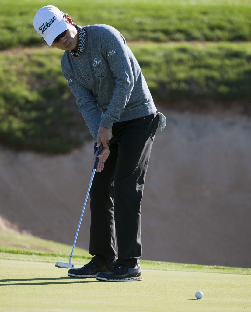 Kevin Na putts on the 15th green during the second round of the Valero Texas Open golf tournament, Friday, March 27, 2015, in San Antonio. (AP Photo/Darren Abate)