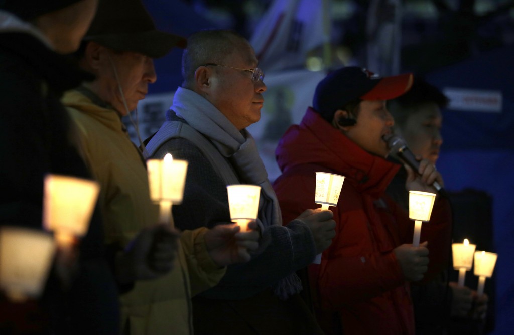 South Koreans hold candles for a quick recovery of injured U.S. Ambassador Mark Lippert at downtown of Seoul, South Korea, Thursday, March 5, 2015. U.S. Ambassador Mark Lippert was in stable condition after a man screaming demands for a unified North and South Korea slashed him on the face and wrist with a knife, South Korean police and U.S. officials said Thursday. (AP Photo/Lee Jin-man)