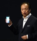 JK Shin, CEO of Samsung's mobile division, shows the new Galaxy S6 and S6 Edge, during a Samsung Galaxy Unpacked 2015 event on the eve of this weeks Mobile World Congress wireless show, in Barcelona, Spain, Sunday, March 1, 2015. Samsung unveiled a stylish new flagship phone that ditches its signature plastic design for metal and glass. The South Korean phone manufacturer also unveiled a premium model with a display that curves around the left and right edges so that information can be quickly glanced at on the side. (AP Photo/Manu Fernandez)