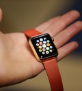 A woman holds the Apple Watch Edition during a demo following an Apple event Monday, March 9, 2015, in San Francisco. Make calls, read email, control music, manage Instagram photos, keep up with your workout, pay for groceries, open your hotel room door. CEO Tim Cook says you can do it all from your wrist with Apple Watch — for 18 hours a day. That's how long the battery will last on an average day. (AP Photo/Eric Risberg)