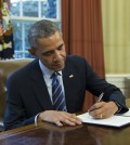 President Barack Obama signs a presidential memorandum aiming to clamp down on the private companies that service federal student debt, Tuesday, March 10, 2015, in the Oval Office of the White House in Washington. (AP Photo/ Evan Vucci)