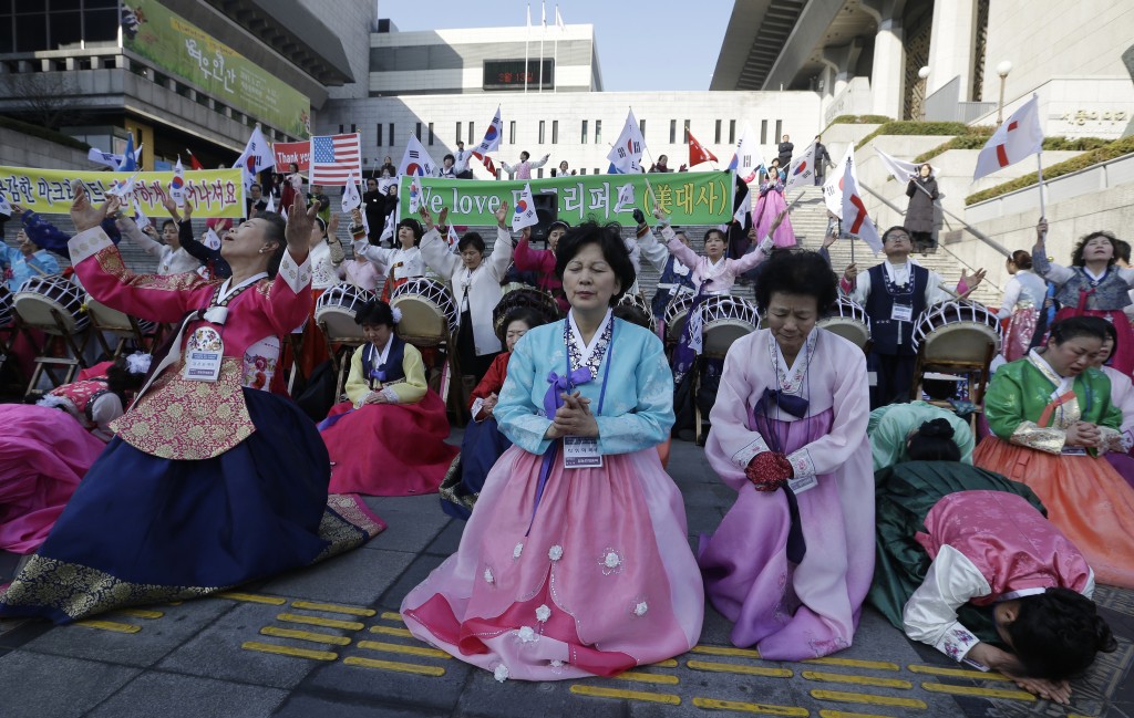 South Korean Christian women pray for the speedy recovery of U.S. Ambassador to South Korea Mark Lippert, during a gathering near the U.S. embassy in Seoul, South Korea, Saturday, March 7, 2015. Police on Friday investigated the motive of the anti-U.S. activist they say slashed the U.S. ambassador to South Korea, as questions turned to whether security was neglected. (AP Photo/Ahn Young-joon)