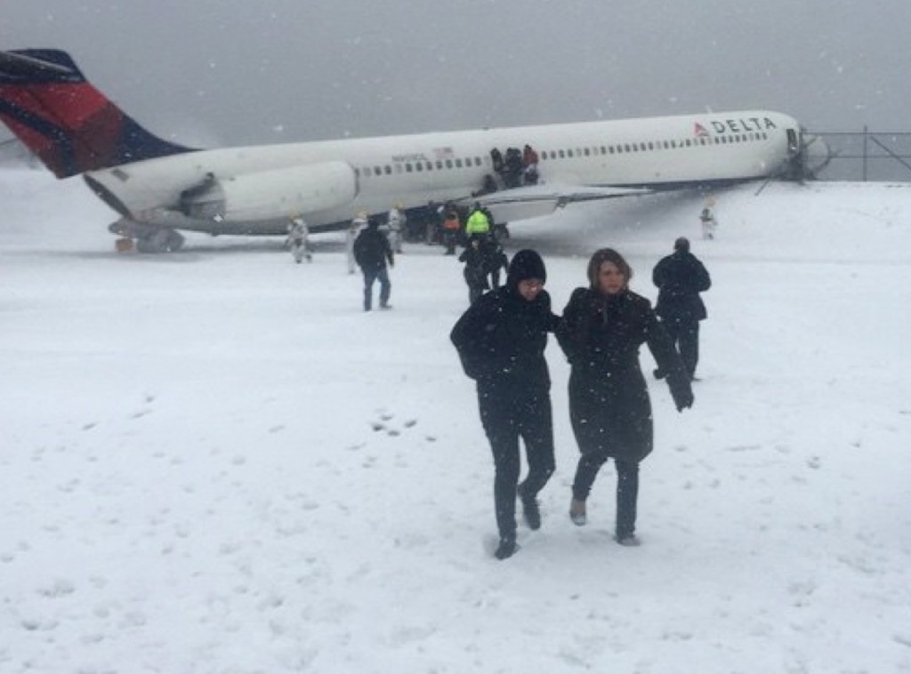 In this image provided by passenger Larry Donnell, a  New York Giants NFL football player, passengers are evacuated after a Delta plane skidded off the runway at LaGuardia Airport during a snowstorm, Thursday, March, 5 2015, in New York. Delta Flight 1086, carrying 125 passengers and five crew members, veered off the runway at around 11:10 a.m., authorities said. Six people suffered non-life-threatening injuries, said Joe Pentangelo, a spokesman for the Port Authority of New York and New Jersey, which runs the airport.  (AP Photo/Larry Donnell)