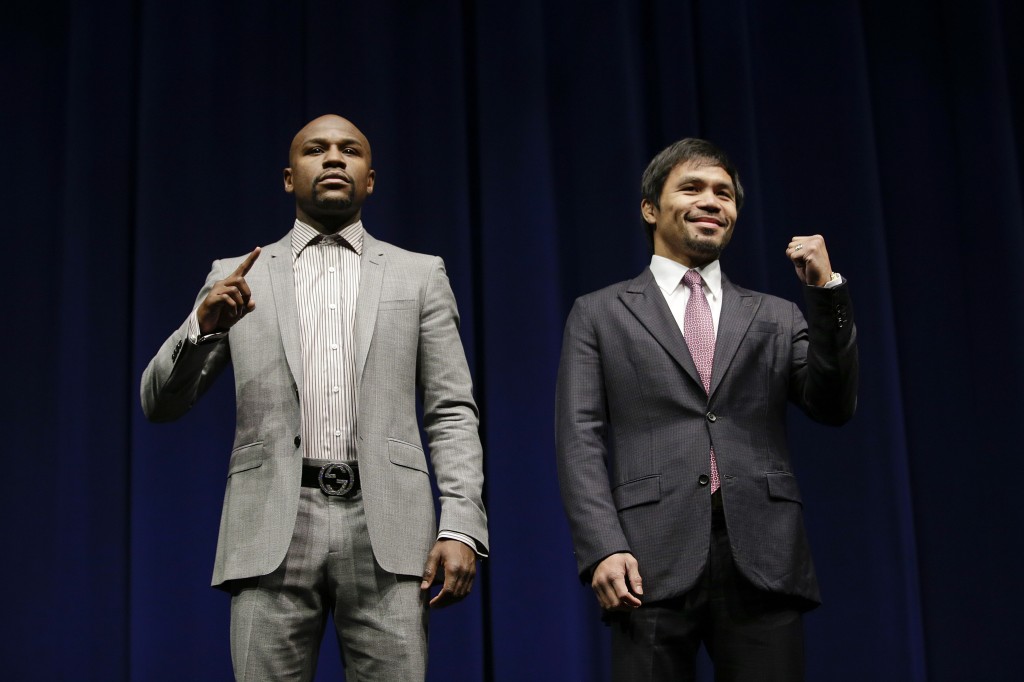 Floyd Mayweather Jr., left, and Manny Pacquiao, of the Philippines, pose for photos during a news conference, Wednesday, March 11, 2015, in Los Angeles. The two are scheduled to fight in Las Vegas on May 2. (AP Photo/Jae C. Hong)