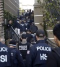 Federal agents enter an upscale apartment complex, Tuesday, March 3, 2015, in Irvine, Calif. Shortly after sunrise, federal agents swarmed the complex in the Orange County where authorities say a birth tourism business charged pregnant women $50,000 for lodging, food and transportation. The key draw for travelers is that the United States offers birthright citizenship. (AP Photo/Jae C. Hong)