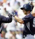 New York Yankees' Robert Refsnyder, center, is congratulated by Jose Pirela (63) after they both scored on Refsnyder's two-run home run during the first inning of a spring training exhibition baseball game against the Detroit Tigers in Lakeland, Fla., Friday, March 20, 2015. (AP Photo/Carlos Osorio)