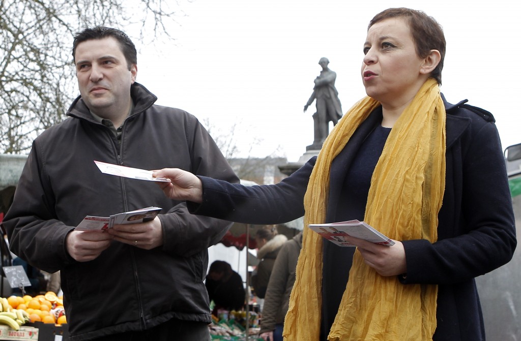 In this picture taken Sunday, March 1, 2015, Fatiha Ihallaine, 45, right, and Francis Andre, 45, candidates of French Socialist Party, campaign at an open market in Lille, northern France. In Frances upcoming local elections, one thing is certain: Women will win half the seats. After years of largely failed efforts to get more women in politics, electoral officials devised a new rule for March 22 and March 29 elections for 4,108 local council members around France.(AP Photo/Michel Spingler)