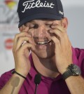 Morgan Hoffmann wipes his eyes during a news conference after finishing in the lead after the first round of the Arnold Palmer Invitational golf tournament in Orlando, Fla., Thursday, March 19, 2015.(AP Photo/Phelan M. Ebenhack)