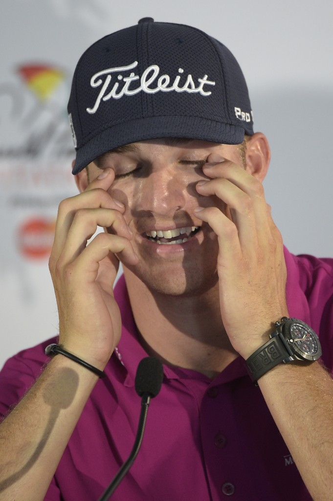 Morgan Hoffmann wipes his eyes during a news conference after finishing in the lead after the first round of the Arnold Palmer Invitational golf tournament in Orlando, Fla., Thursday, March 19, 2015.(AP Photo/Phelan M. Ebenhack)