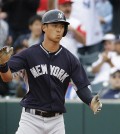 New York Yankees' Robert Refsnyder claps his hands after hitting a single to score teammates Jonathan Galvez and Jake Cave in the ninth inning of an exhibition spring training baseball game against the Houston Astros, Saturday, March 7, 2015, in Kissimmee, Fla. (AP Photo/David Goldman)