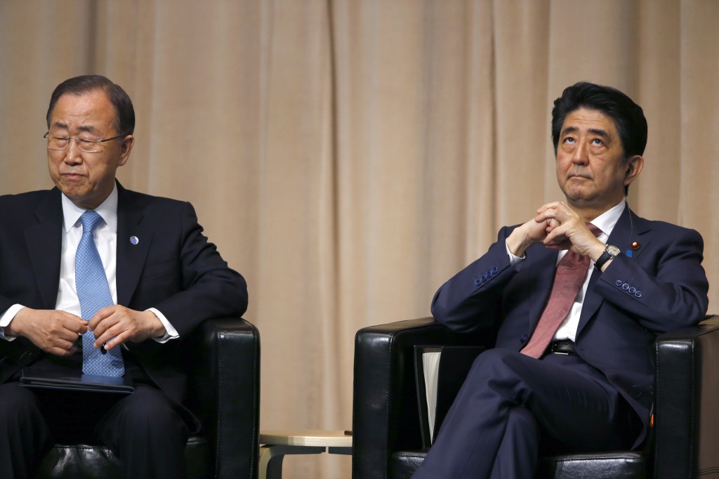 U.N. Secretary General Ban Ki-moon, left, and Japanese Prime Minister Shinzo Abe attend a symposium of the 70th anniversary of the United Nations at the UN University in Tokyo, Monday, March 16, 2015. (AP Photo/Shizuo Kambayashi)