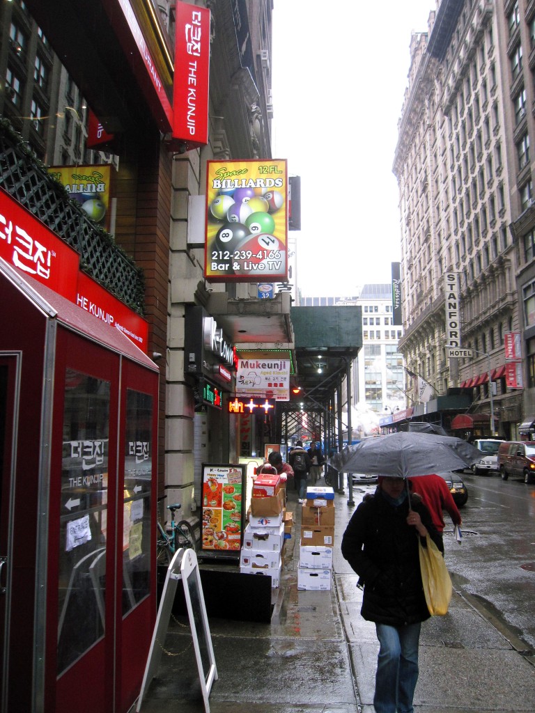 This March 25, 2015 photo shows West 32nd Street in Manhattan, also known as Korea Way or Koreatown. The enclave is home to numerous Asian businesses, including Korean restaurants and karaoke bars. (AP Photo/Beth J. Harpaz)