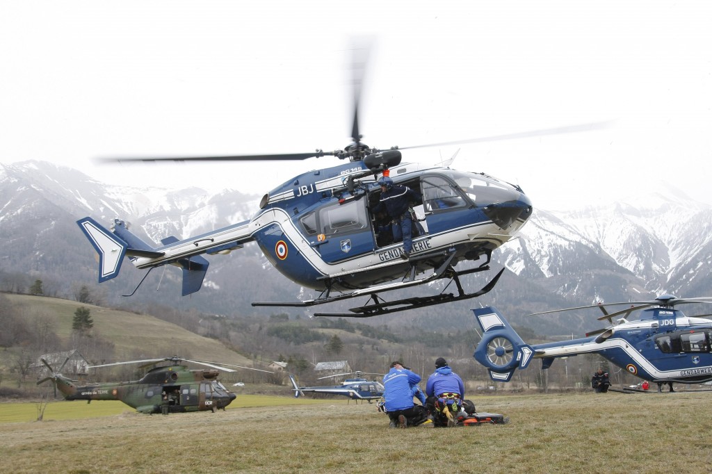An helicopter takes off at Seyne les Alpes, French Alps, Tuesday, March 24, 2015. A Germanwings passenger jet carrying at least 150 people crashed Tuesday in a snowy, remote section of the French Alps, sounding like an avalanche as it scattered pulverized debris across the mountain. (AP Photo/Claude Paris)