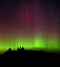 The aurora borealis, or the northern lights as they are commonly known are photographed, over Dunstanburgh Castle, in Northumberland, England (AP Photo/PA, Owen Humphreys)