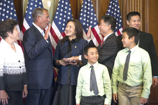 House Speaker John Boehner of Ohio administers a ceremonial re-enactment of the House oath-of-office to Rep. Ted Lieu D-Calif., accompanied by his wife Betty Lieu and family, Tuesday, Jan. 6, 2015, on Capitol Hill in Washington. (AP Photo/Cliff Owen)