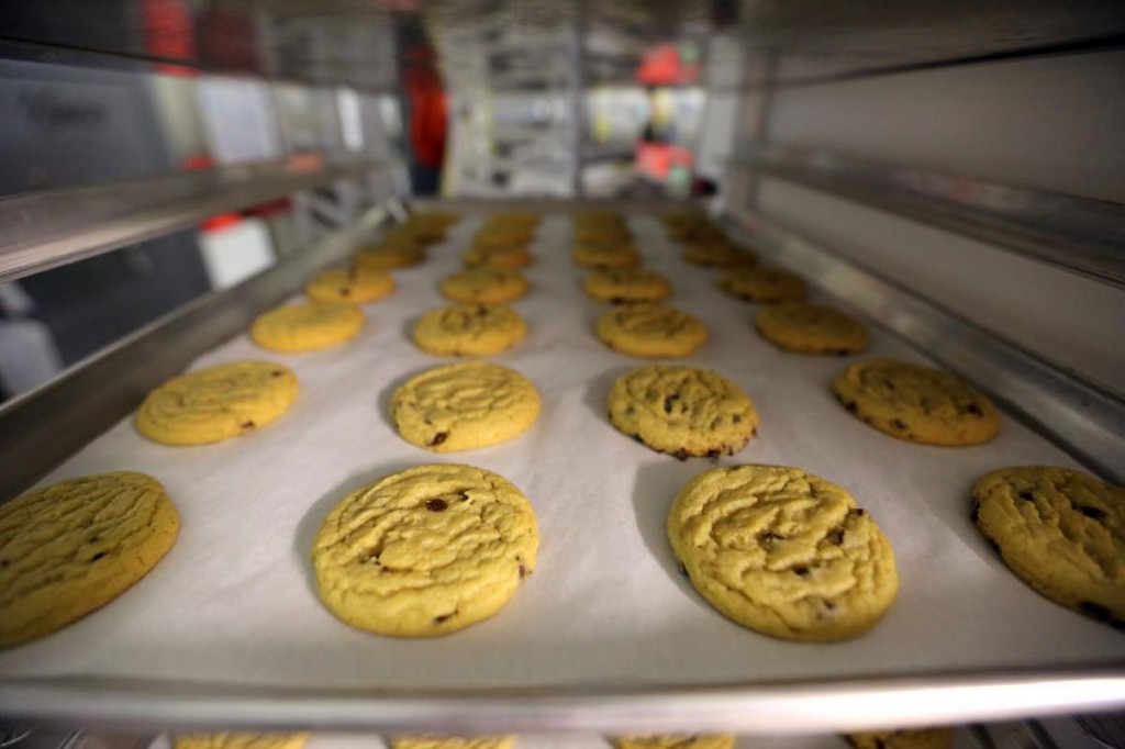 Freshly baked cannabis-infused cookies cool on a rack inside Sweet Grass Kitchen, an established Denver-based gourmet marijuana edibles bakery which sells its confections to retail outlets throughout the state. Edible marijuana sold in Colorado must look different from regular foods, state lawmakers from both parties said Wednesday, March 25, 2015, in rejecting a bill to loosen requirements. The 0-5 vote was a dramatic loss for the state’s new marijuana industry, where many producers of edible pot complain that a requirement that their products not look like other foods and drinks goes too far. (AP Photo/Brennan Linsley, File)