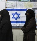 Bedouin women wait to cast their votes at a polling station in the town of Rahat, Tuesday, Mar. 17, 2015. Israelis are voting in early parliament elections following a campaign focused on economic issues such as the high cost of living, rather than fears of a nuclear Iran or the Israeli-Arab conflict. (AP Photo/Tsafrir Abayov)
