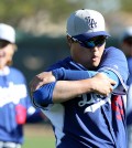 Ryu Hyun-jin stretches his shoulder on Sunday, but could not throw without discomfort. (Yonhap)