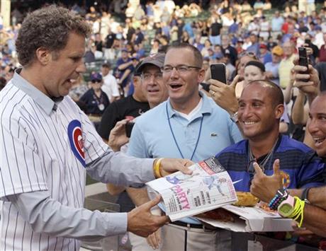 FILE - In this July 18, 2012, file photo, comedian Will Ferrell, left, talks with fans after throwing out the ceremonial first pitch before a baseball game between the Miami Marlins and the Chicago Cubs in Chicago. Ferrell will appear in at least two Arizona spring training games on Thursday, March 12, 2015. The Chicago White Sox confirmed the star of "Anchorman" and many other movies will appear in their game against the San Francisco Giants in Glendale and the San Diego Padres say he will play in their game against the Los Angeles Dodgers in Peoria. (AP Photo/Nam Y. Huh, File)