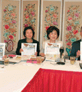 Representatives from the KACC, the NVGPA and KCC hold up posters of the upcoming festival.