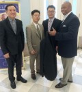Jung Young-hoon, former president of the Korean Dry Cleaners Association of New York, left, association Vice President Seo Jung-woo, center, and President Kim Sang-gyun, second from right, hand a "Clothing of Love" donation to Brooklyn Borough President Eric Adams, right, Monday.