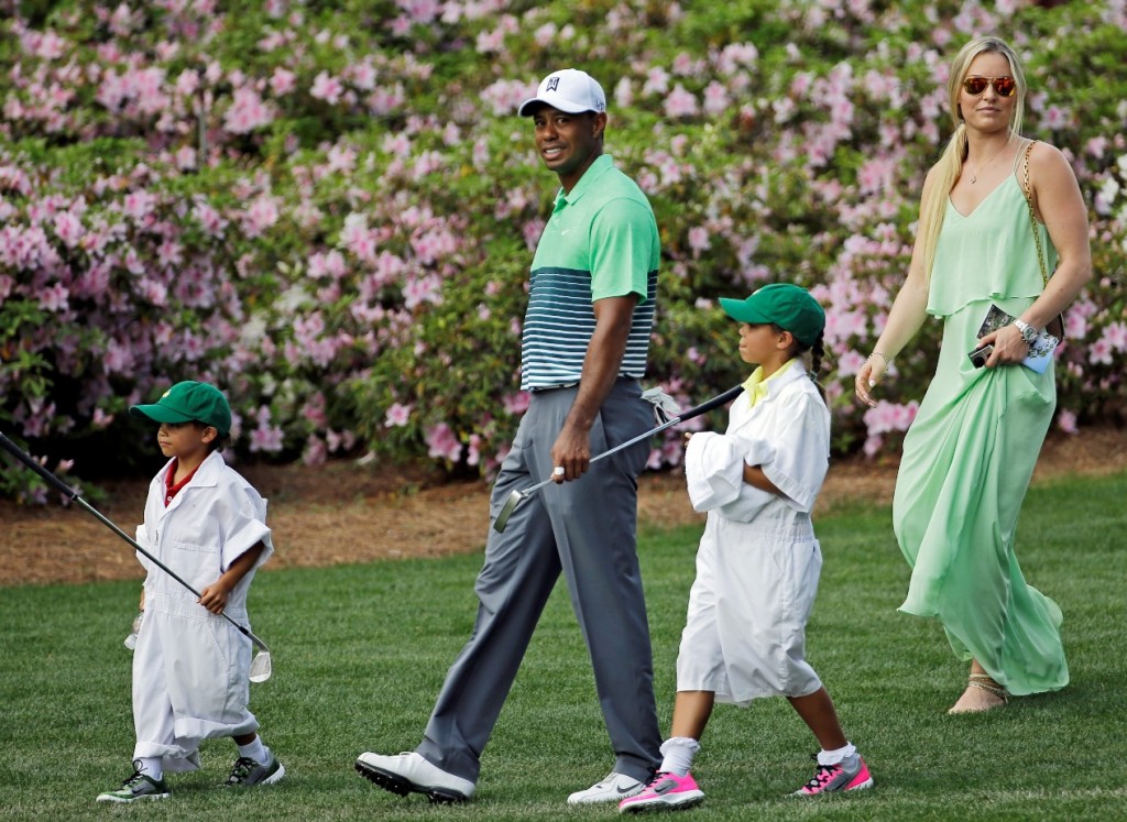 Tiger Woods walks with his children Sam and Charlie and Lindsey Vonn during the Par 3 contest at the Masters golf tournament Wednesday, April 8, 2015, in Augusta, Ga. (AP Photo/David J. Phillip) 