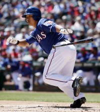 Texas Rangers' Shin-Soo Choo, of South Korea, reaches first after safely bunting down the third base line off a pitch from New York Mets' Dillon Gee in the first inning of an exhibition baseball game, Saturday April 4, 2015, in Arlington, Texas. (AP Photo/Tony Gutierrez)