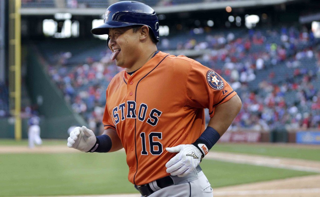 Houston Astros' Hank Conger heads to the dugout after hitting a two-run home run during the 14th inning of a baseball game against the Texas Rangers in Arlington, Texas, Sunday, April 12, 2015. (AP Photo/LM Otero)