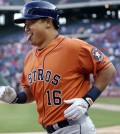 Houston Astros' Hank Conger heads to the dugout after hitting a two-run home run during the 14th inning of a baseball game against the Texas Rangers in Arlington, Texas, Sunday, April 12, 2015. (AP Photo/LM Otero)