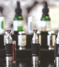 This Wednesday, April 23, 2014 photo shows electronic cigarettes and accessories displayed at a store in Chicago. For the first time, a government survey released on Thursday, April 16, 2015 says U.S. teen cigarette smoking fell below 10 percent, but dramatic increases in teens puffing electronic cigarettes and hookahs offset the use of traditional nicotine products like cigarettes, cigars, pipes, and chewing tobacco. (AP Photo/Nam Y. Huh)