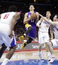 Los Angeles Clippers' J.J. Redick, right, tries to steal the ball from Los Angeles Lakers' Jeremy Lin, center, as Clippers' DeAndre Jordan, foreground, and Blake Griffin watch during the second half of an NBA basketball game, Tuesday, April 7, 2015, in Los Angeles. The Clippers won 105-100. (AP Photo/Jae C. Hong)