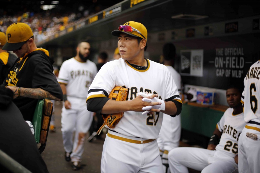 Pittsburgh Pirates' Jung Ho Kang of Korea, prepares to take the field during the seventh inning of a baseball game against the Milwaukee Brewers in Pittsburgh, Sunday, April 19, 2015. Kang took over at shortstop when Jordy Mercer was hit by a pitch and left the game. (AP Photo/Gene J. Puskar)