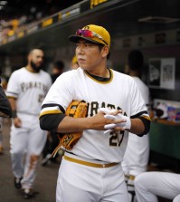 Pittsburgh Pirates' Kang Jung-ho of Korea, prepares to take the field during the seventh inning of a baseball game against the Milwaukee Brewers in Pittsburgh, Sunday, April 19, 2015. Kang took over at shortstop when Jordy Mercer was hit by a pitch and left the game. (AP Photo/Gene J. Puskar)