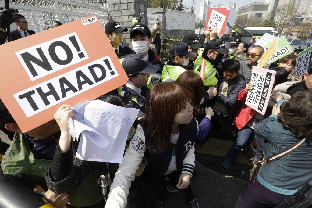 Protesters struggle with police officers as they march toward the Defense Ministry during a rally against the visit by U.S. Defense Secretary Ash Carter in Seoul, South Korea, Friday, April 10, 2015. Protesters opposed a possible deployment of a Terminal High-Altitude Area Defense (THAAD) system on Korea Peninsula. (AP Photo/Ahn Young-joon)